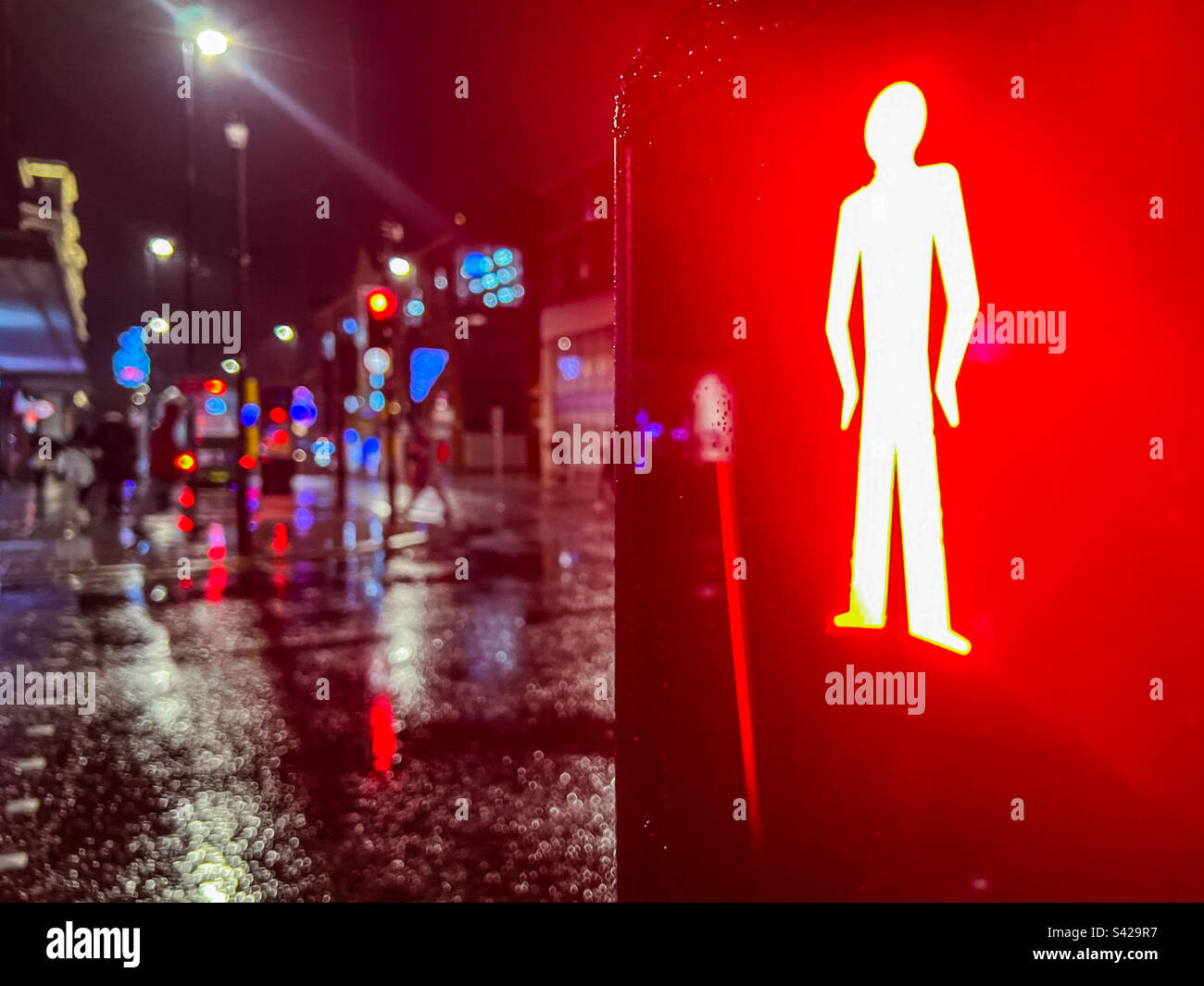 Red man light at pedestrian crossing at night in city centre Stock Photo