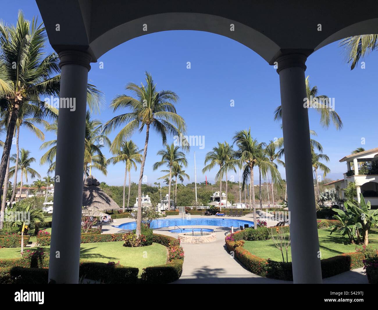 View of a pool through an archway. - Smartphone Captured Stock Image