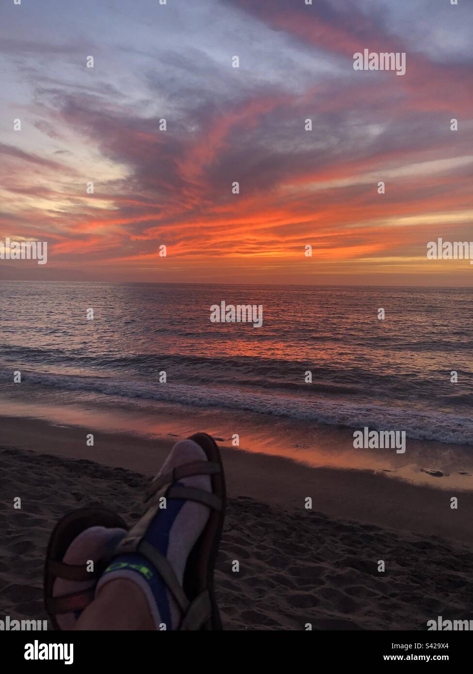 Woman watching sunset at beach hi-res stock photography and images - Alamy