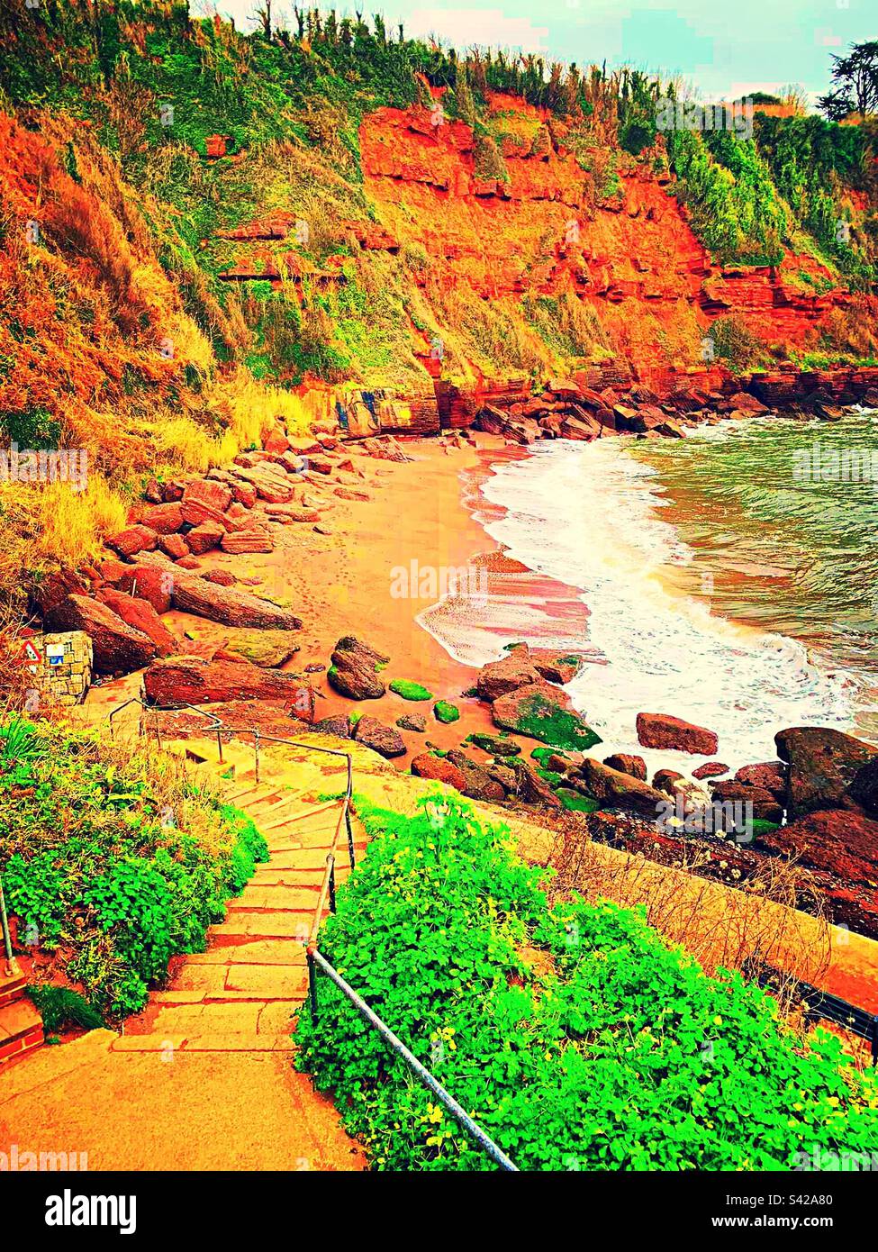 beach in Torquay is a small sandy beach surrounded by red