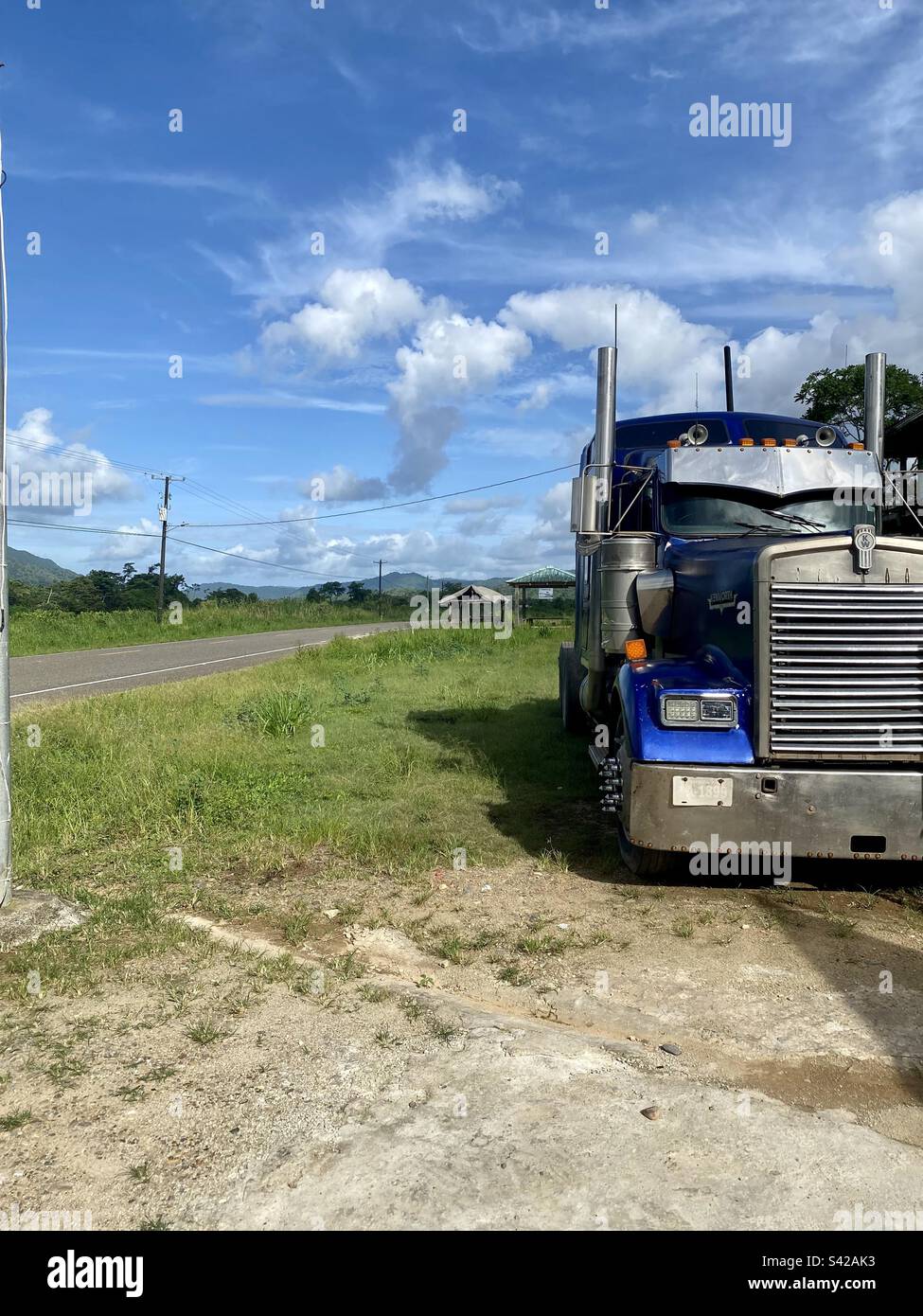 Semi truck parked on the side of Hummingbird Highway in Middlesex, Stann Creek District, Belize - Smartphone Captured Stock Image