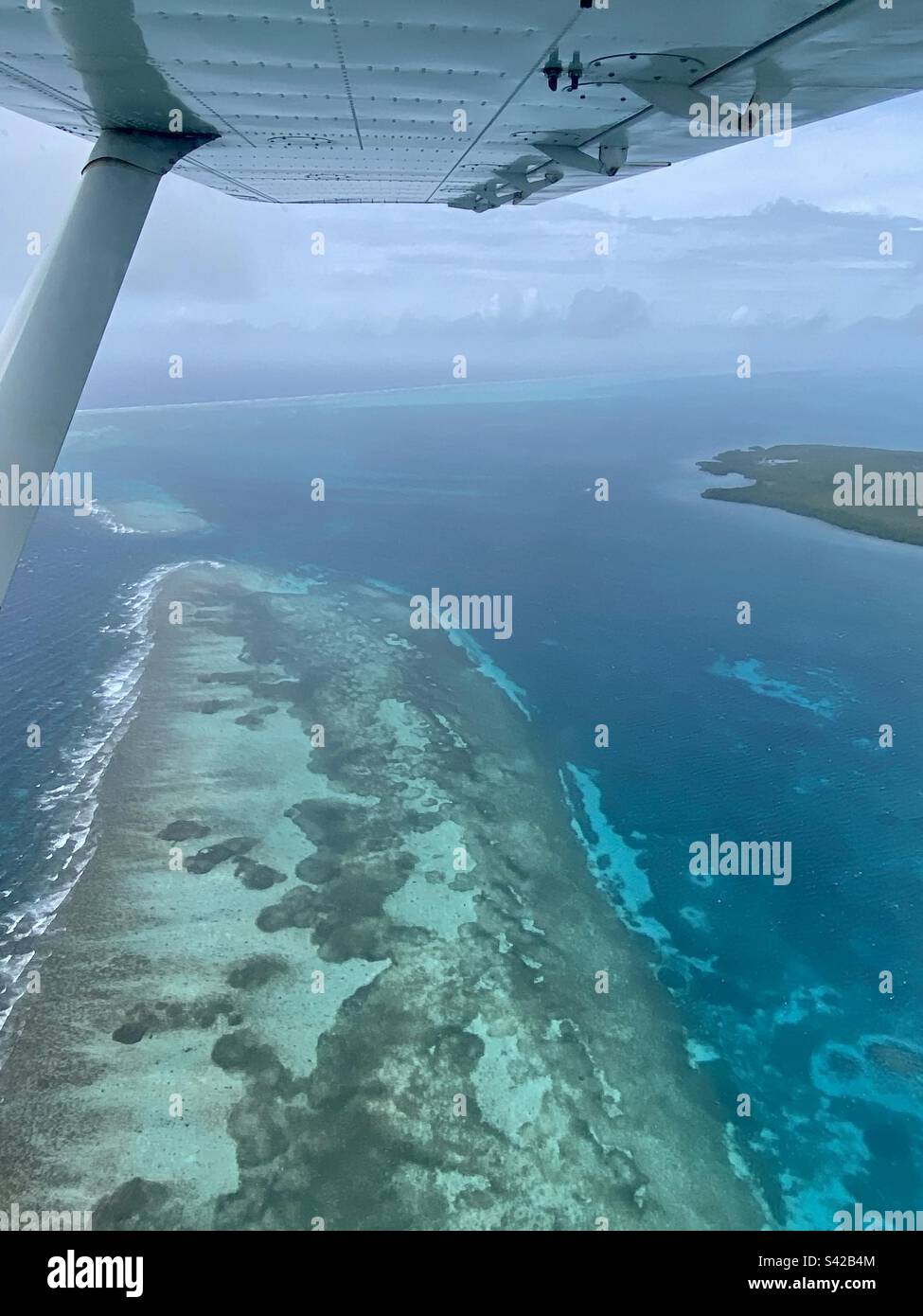 Mixed blues water in Belize Barrier Reef Reserve as viewed from a small airplane Stock Photo