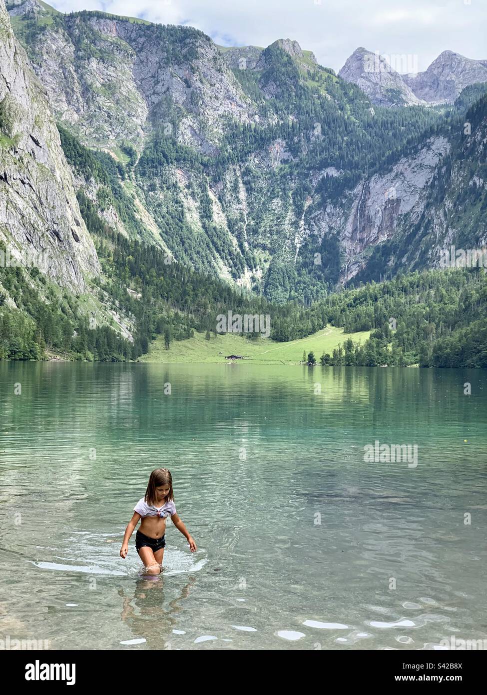 Girl playing in Konigssee Lake Stock Photo