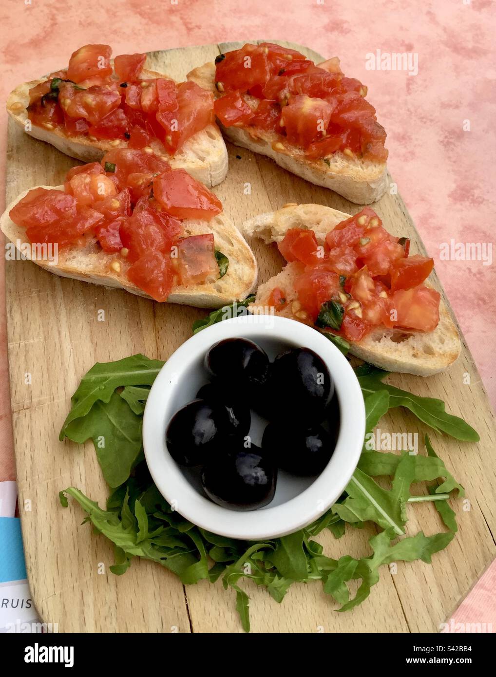 Bruschetta and black olives on a board Stock Photo