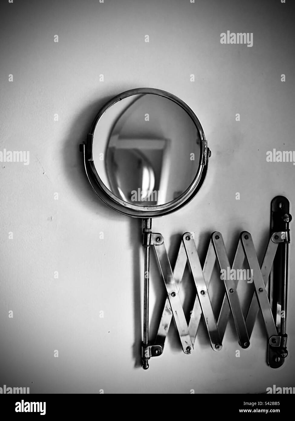 Extendable shaving mirror, magnified side showing, reflecting large