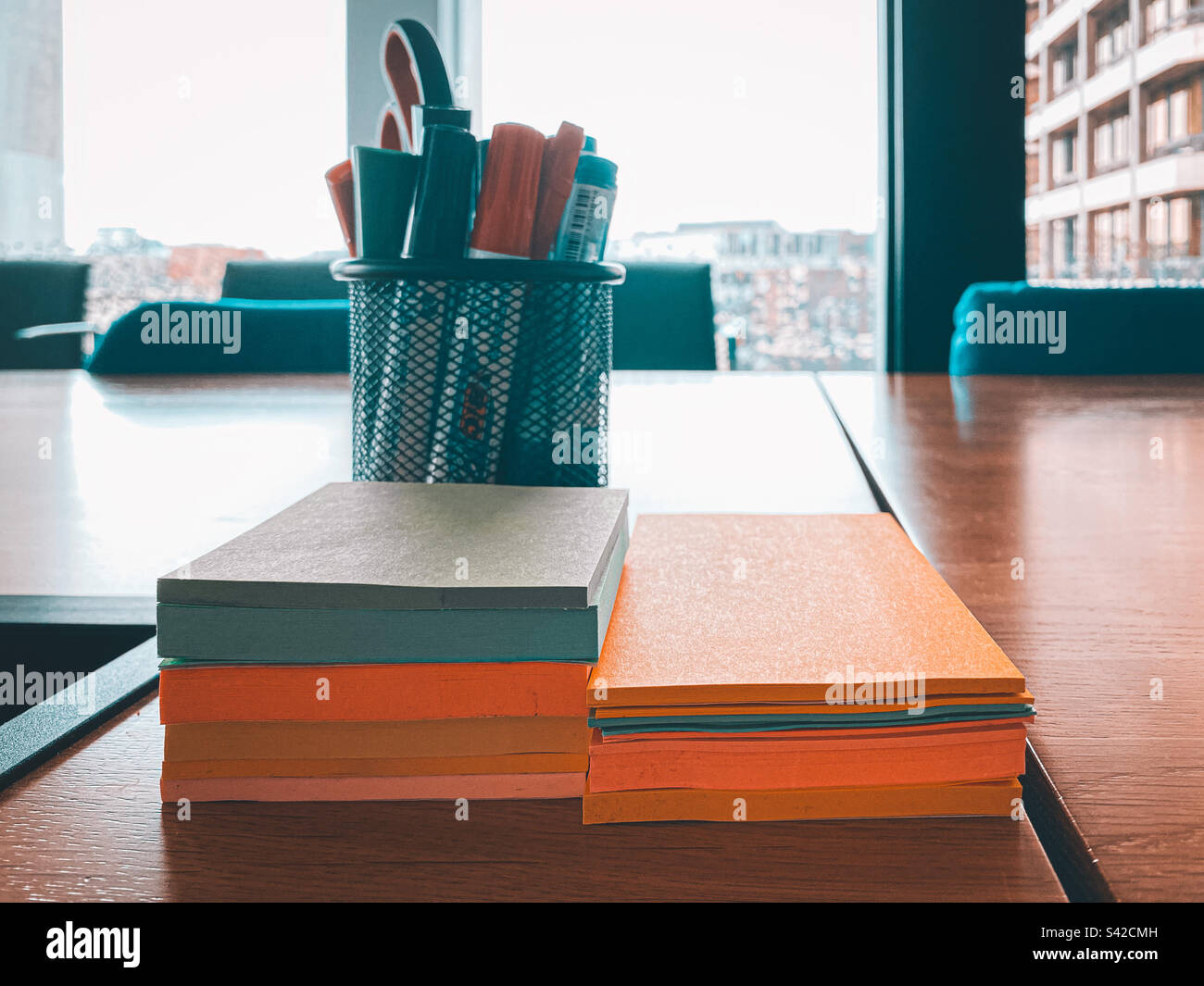Sticky notes and a pot of pens on an office meeting room table. - Smartphone Captured Stock Image