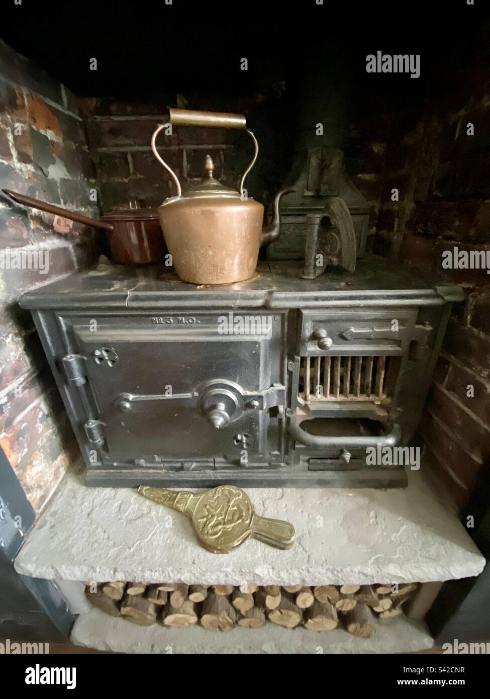 Edwardian cooking range nestled in inglenook fireplace Stock Photo