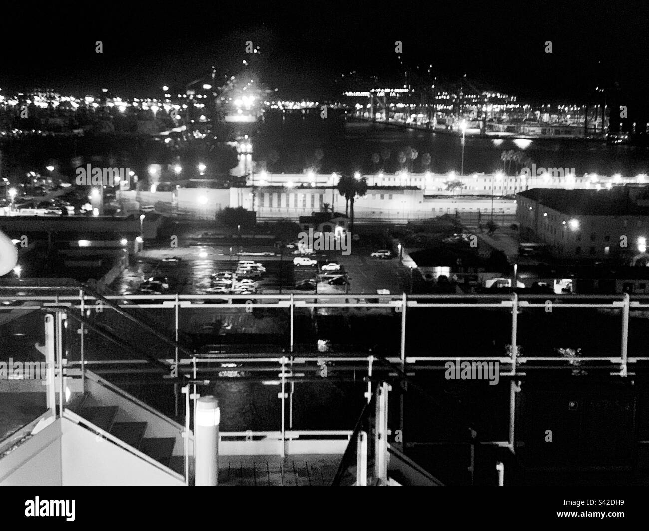 Black and white image from a cruise ship at a port at night - Smartphone Captured Stock Image