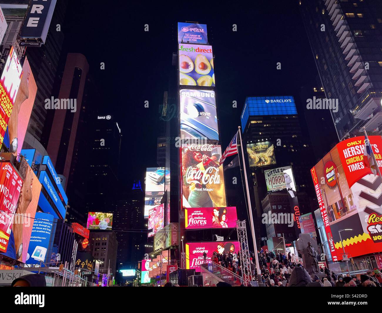 View of Times Square at night with its bright billboards, illuminated