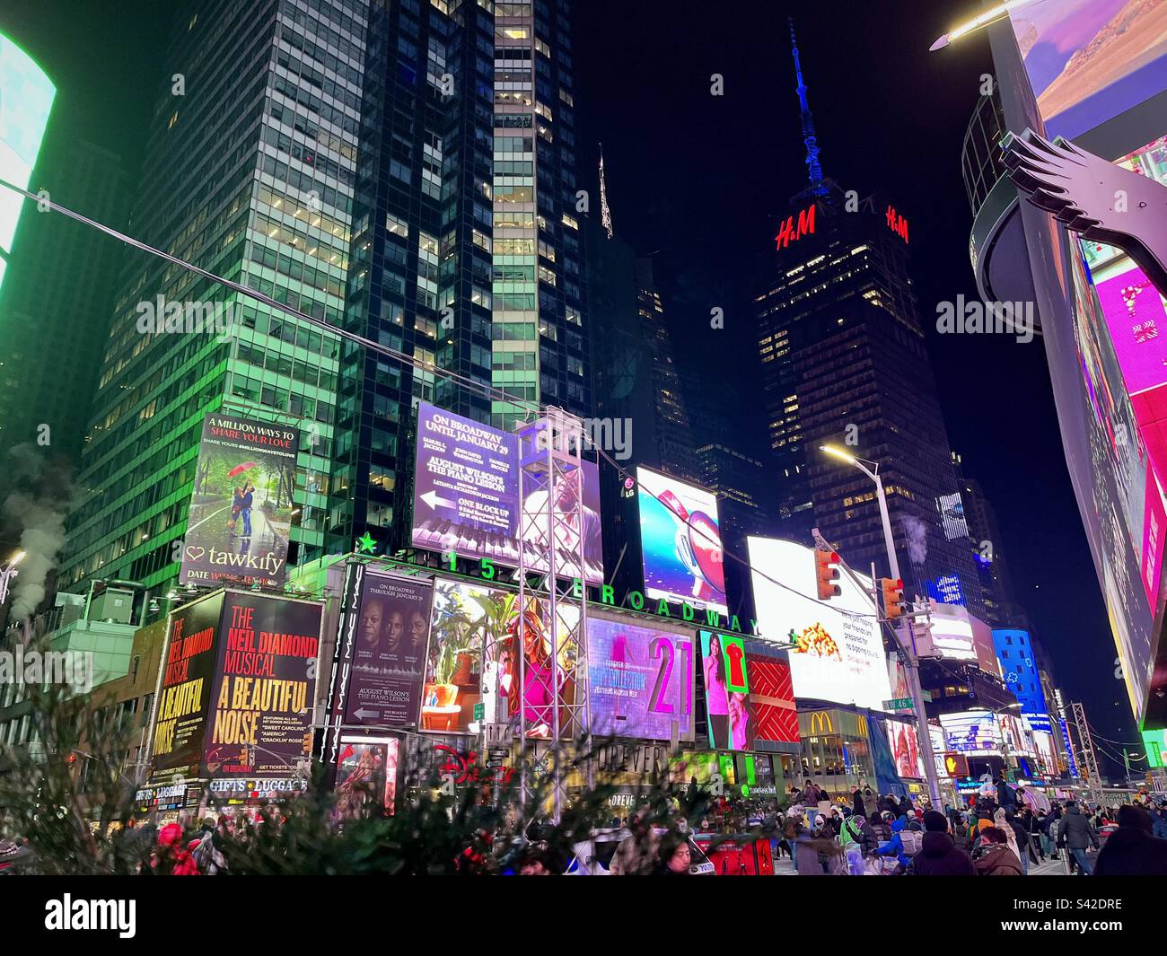 View of Times Square at night with its bright billboards, illuminated