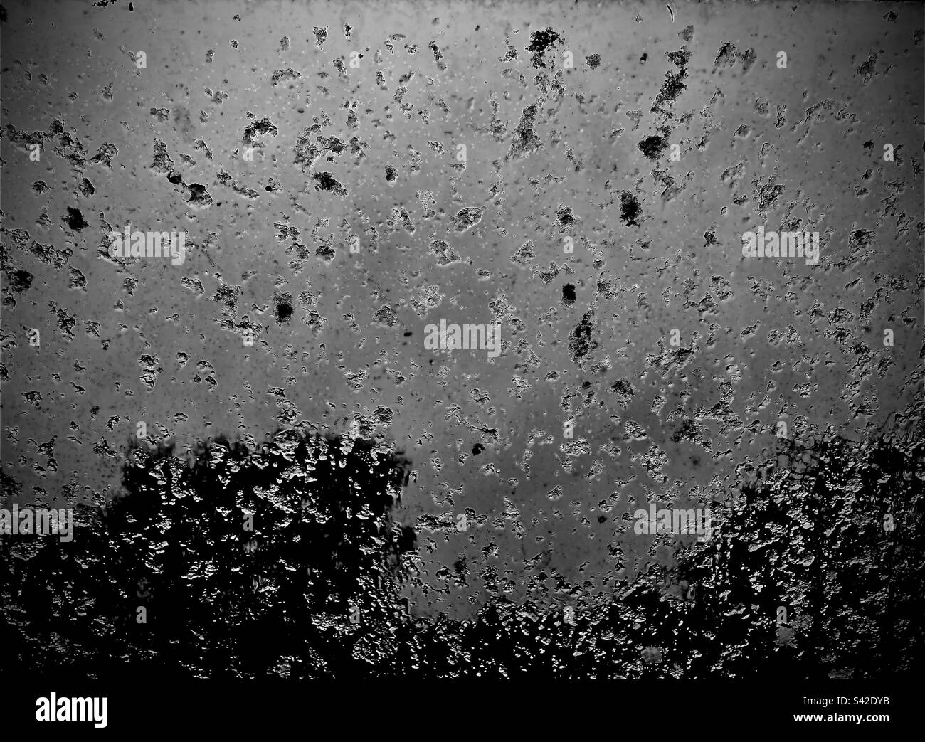 Snowfall captured through a velux window Stock Photo