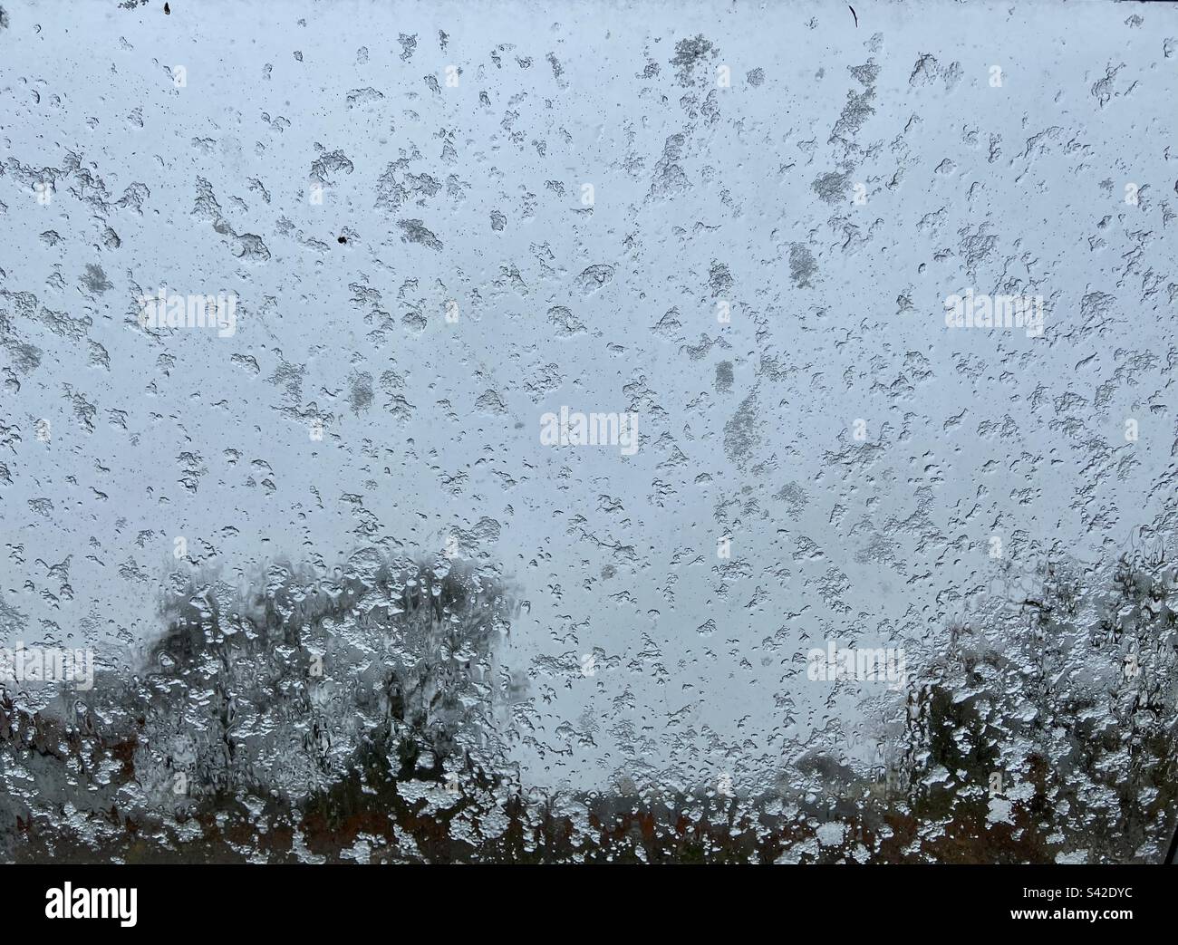 Snowfall captured through velux window Stock Photo