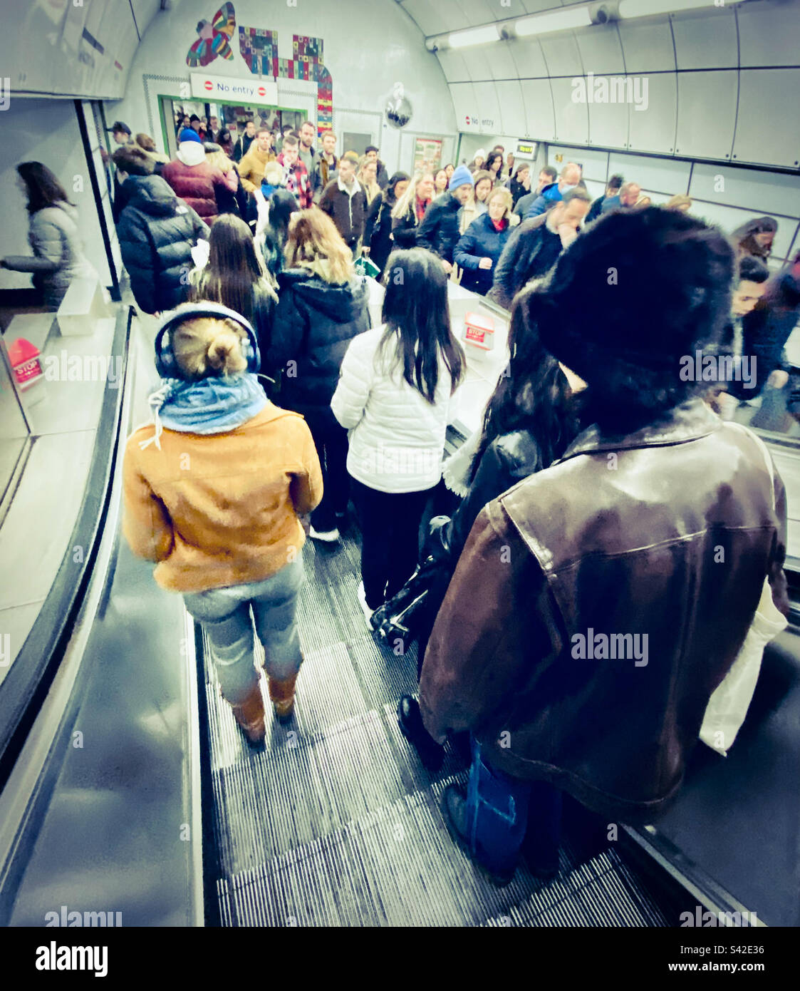People on an escalator going down to the underground in London - Smartphone Captured Stock Image