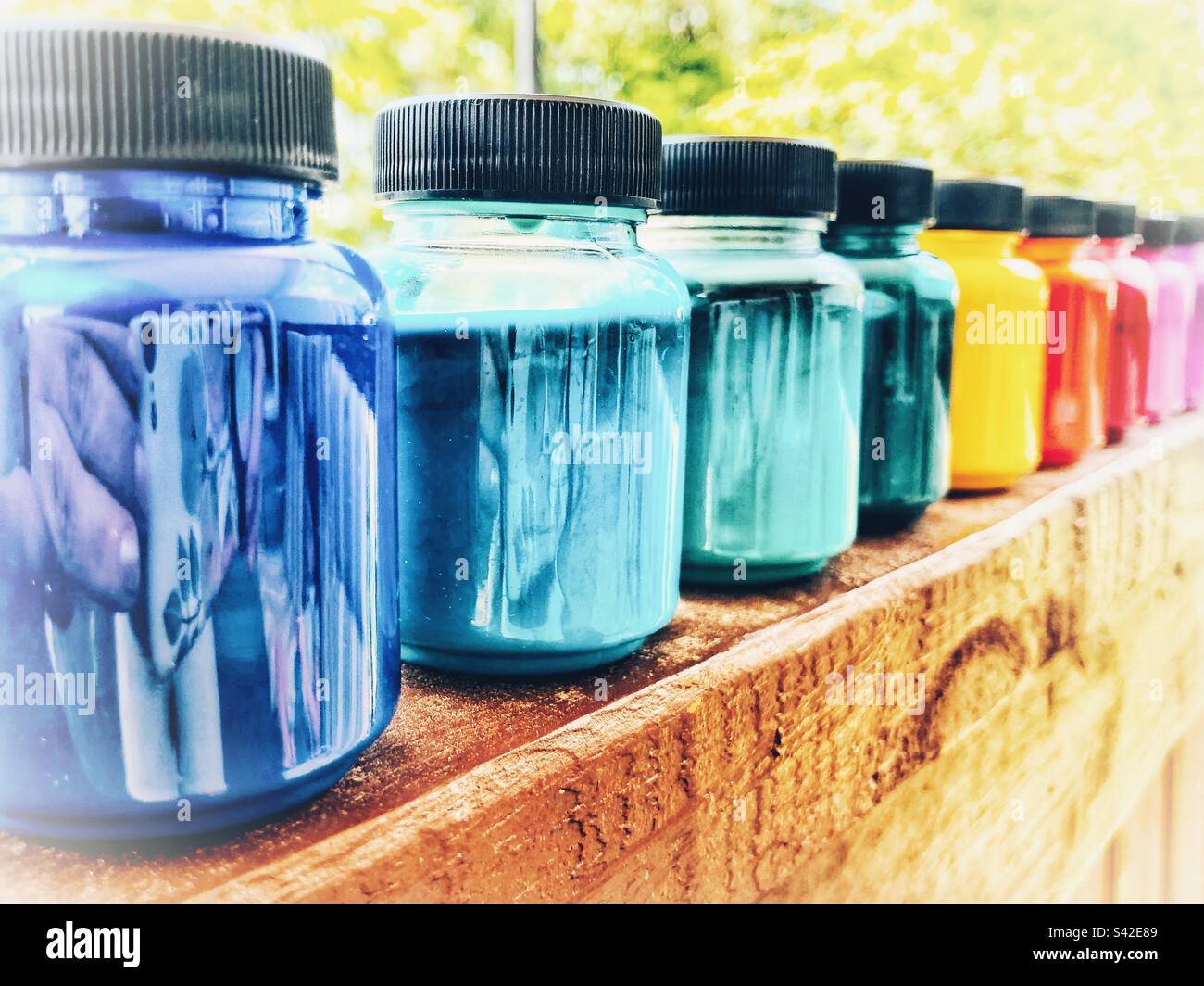 Paint bottles lined up by color Stock Photo Alamy