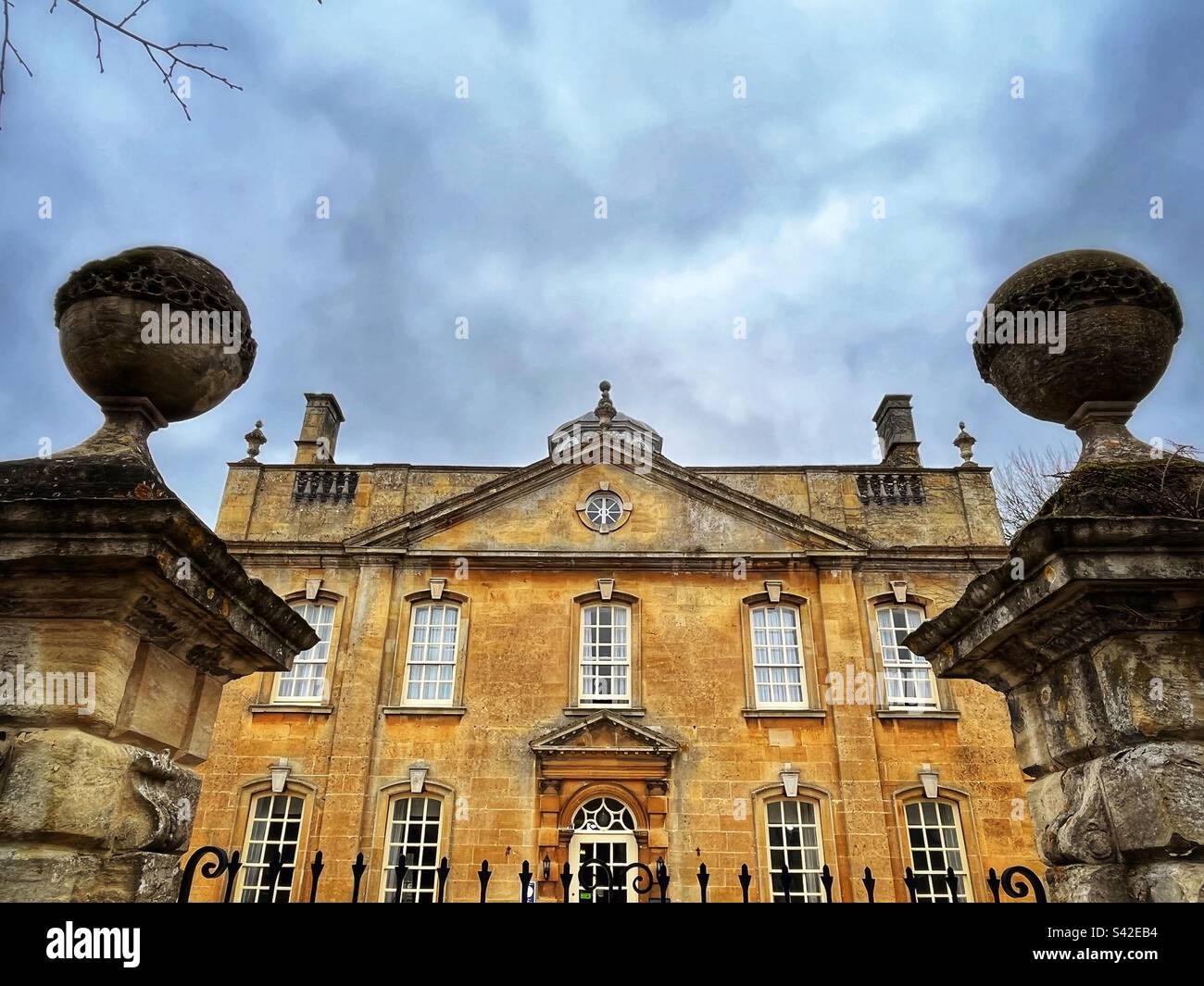 The facade of a former grandiose home made from Cotswold stone in Bourton-on-the-Water, a village and civil parish in Gloucestershire, England. Stock Photo