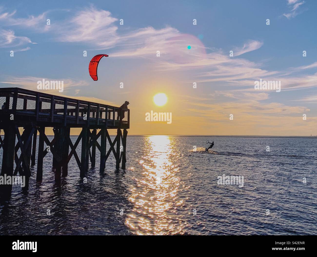 Kitesurfing on Mobile Bay at sunset Stock Photo