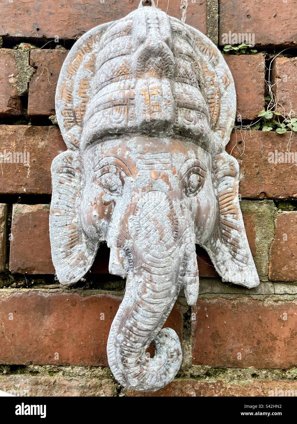 Weathered copper outdoor wall hanging of Lord Ganesh Stock Photo