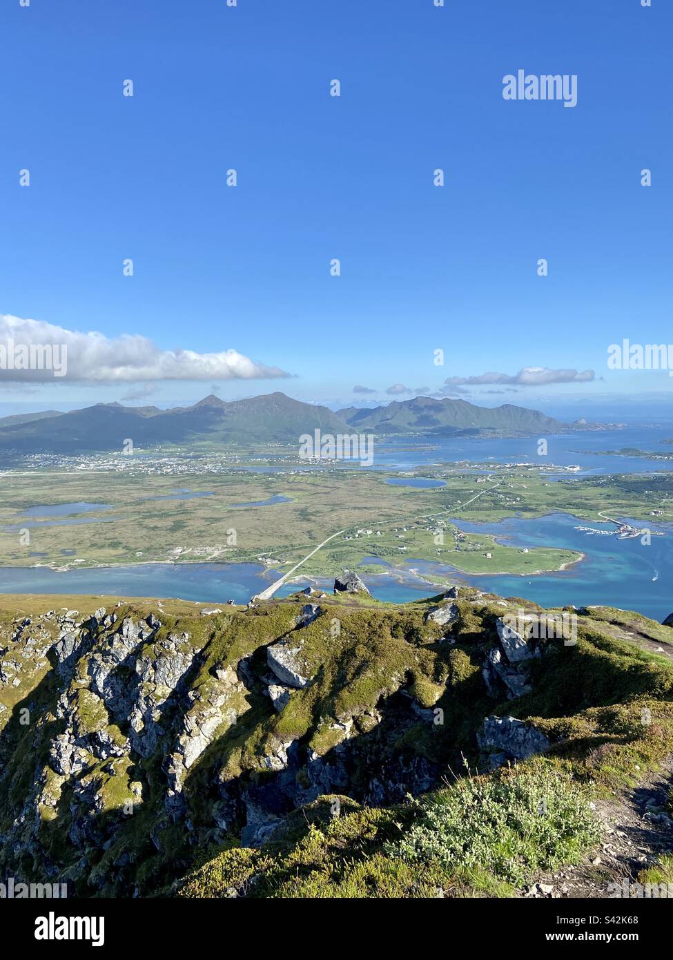 View from mountain top Offersøykammen in Lofoten islands on a sunny summer afternoon. You can see town Leknes further away. Stock Photo