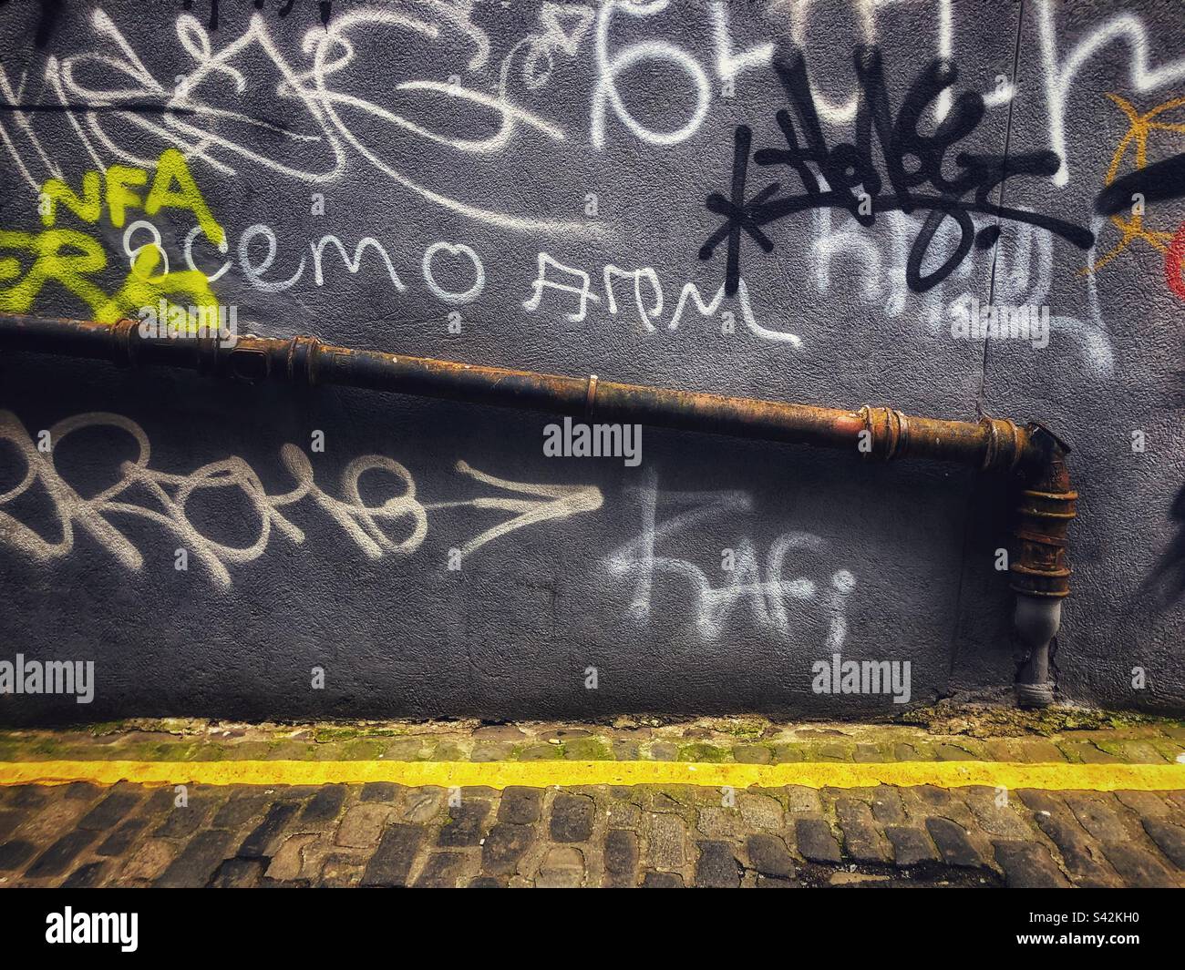 Urban Squalor Graffiti wall in alley - Smartphone Captured Stock Image