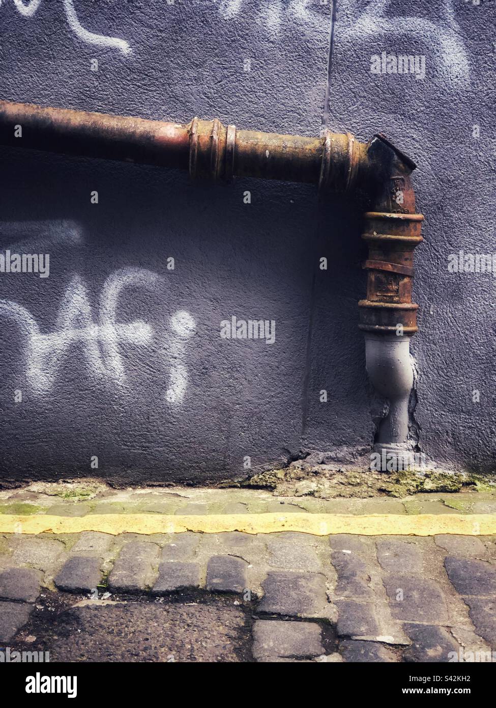 Urban Squalor Graffiti wall in alley - Smartphone Captured Stock Image