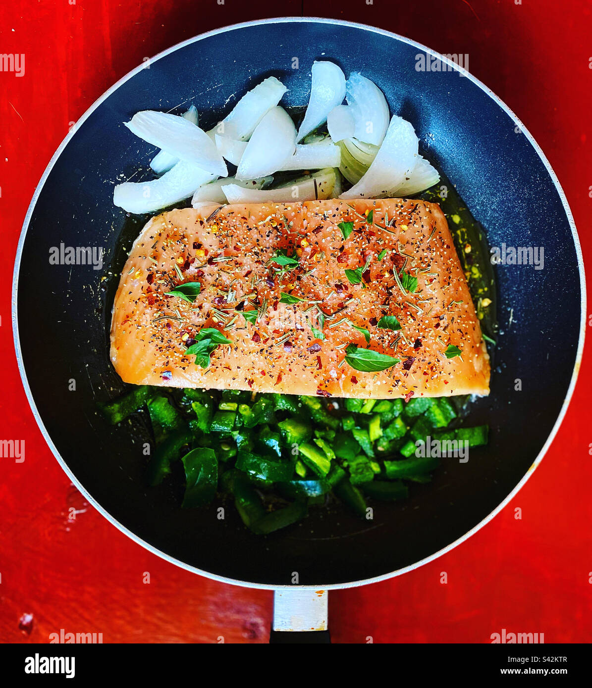 Salmon grilled filet, onion and green chilli peppers ready to be fried in a home in Queretaro, México - Smartphone Captured Stock Image