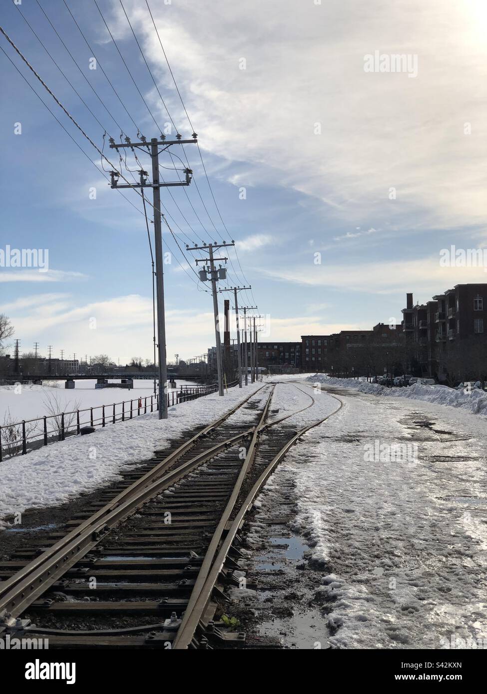 Railroad tracks in old area of Montreal, Quebec, Canada laying in snow. - Smartphone Captured Stock Image