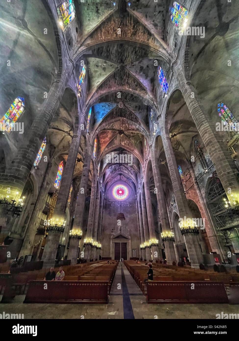 Looking down the aisle in the Cathedral, Palma de Mallorca - the full majestic view with light shining through the window - Smartphone Captured Stock Image