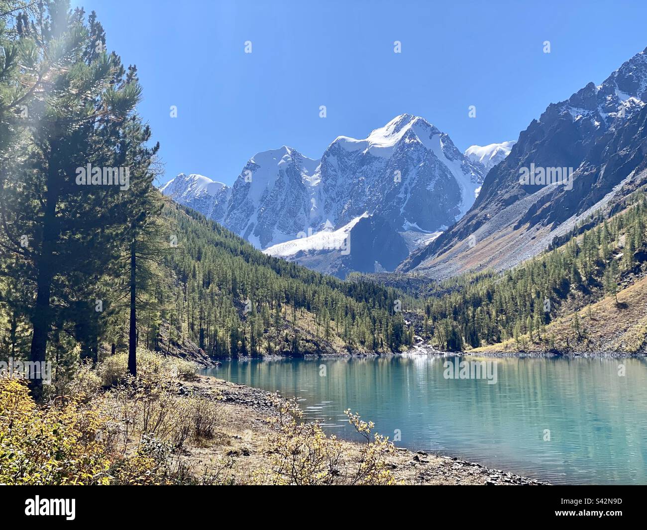 Mountain lake Shavlinskoye among rocks with glaciers in Altai on a sunny day. - Smartphone Captured Stock Image
