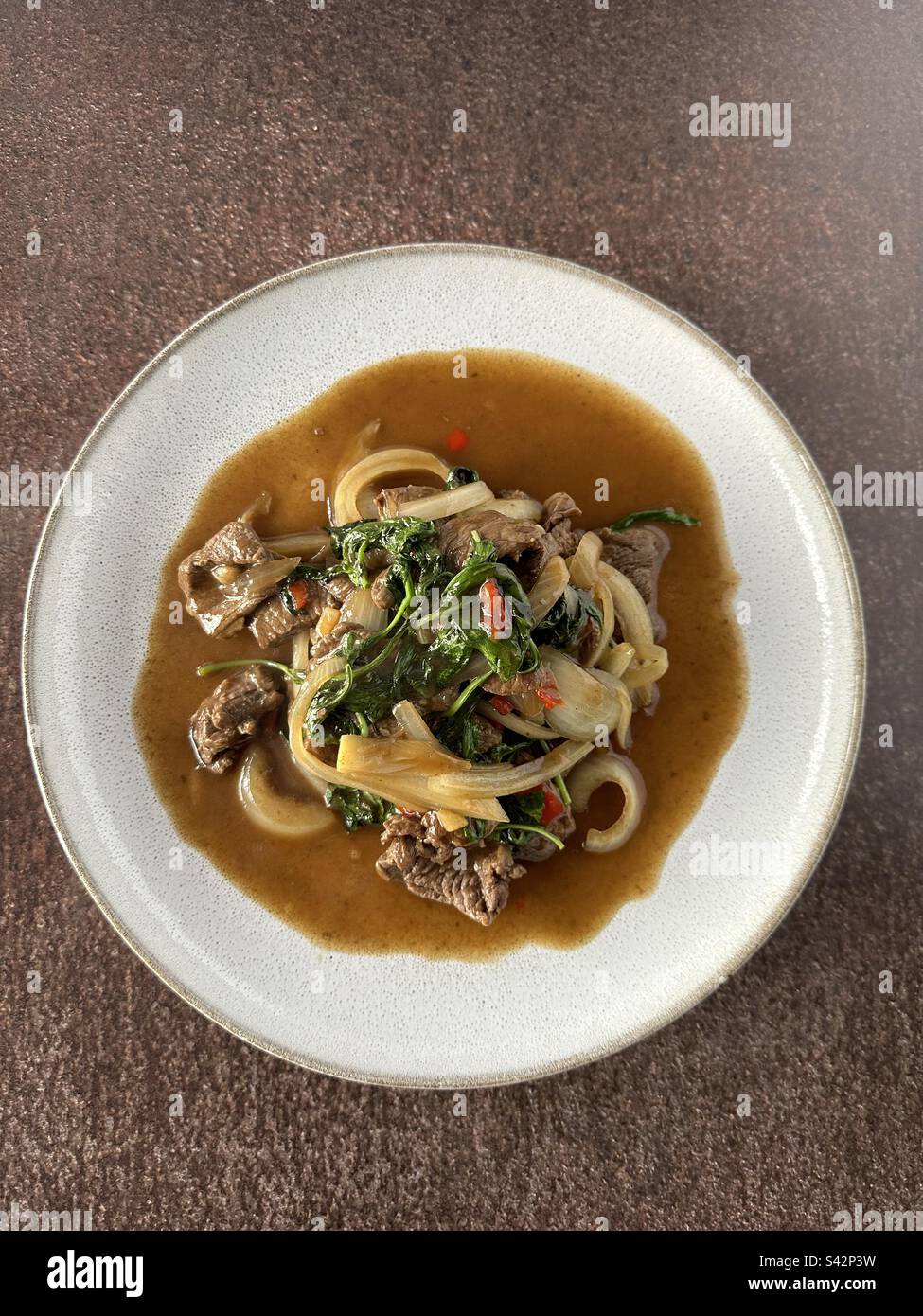 Beef with basil, onions and chilly Stock Photo Alamy