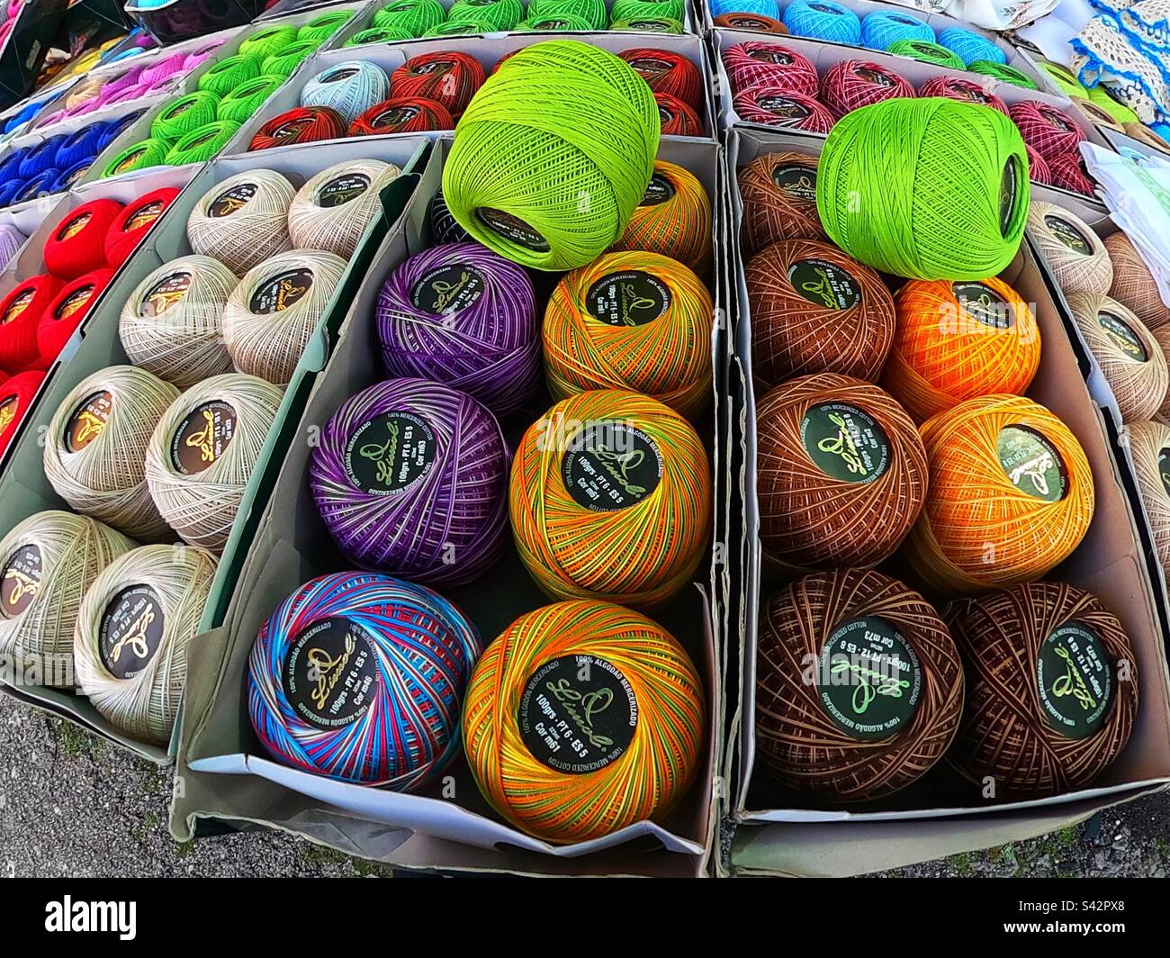 Colourful crochet yarns on the market stand in Espinho, Portugal, 2023 Stock Photo