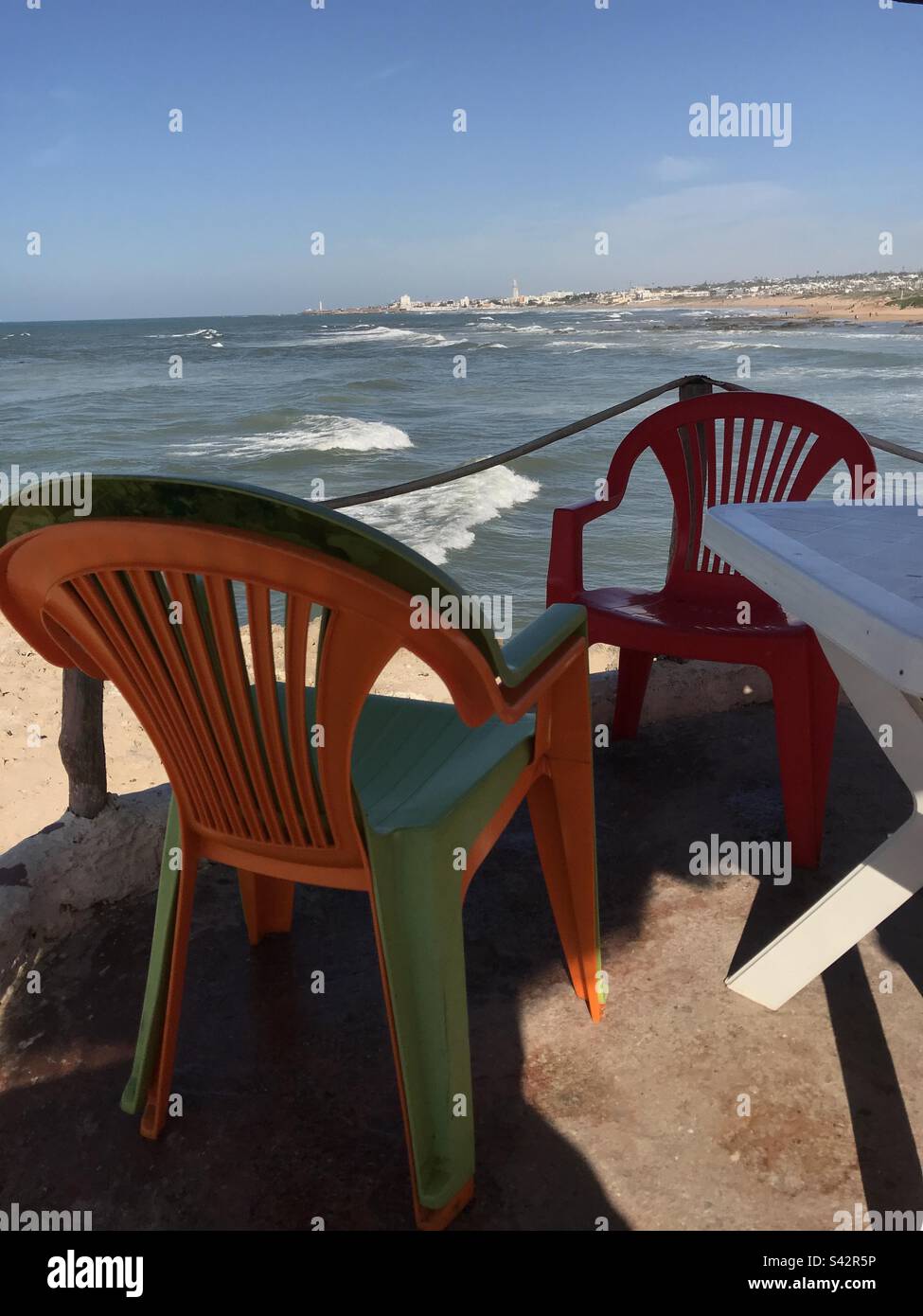 Monobloc Chairs on beach Stock Photo