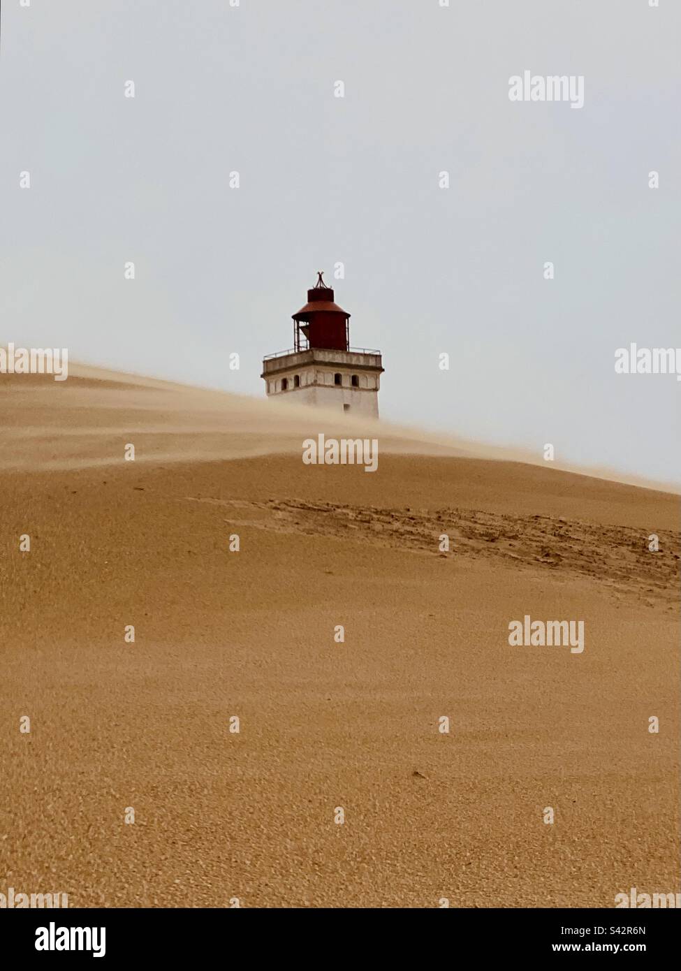 Lighthouse behind a sand dune - Smartphone Captured Stock Image