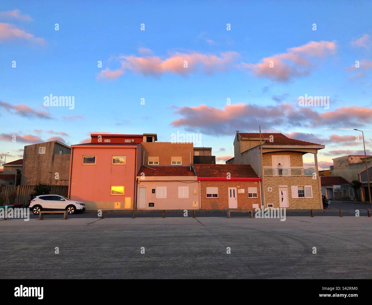 Houses of the oceanfront in Espinho, Portugal during “golden hour” sunset time, 2023 - Smartphone Captured Stock Image