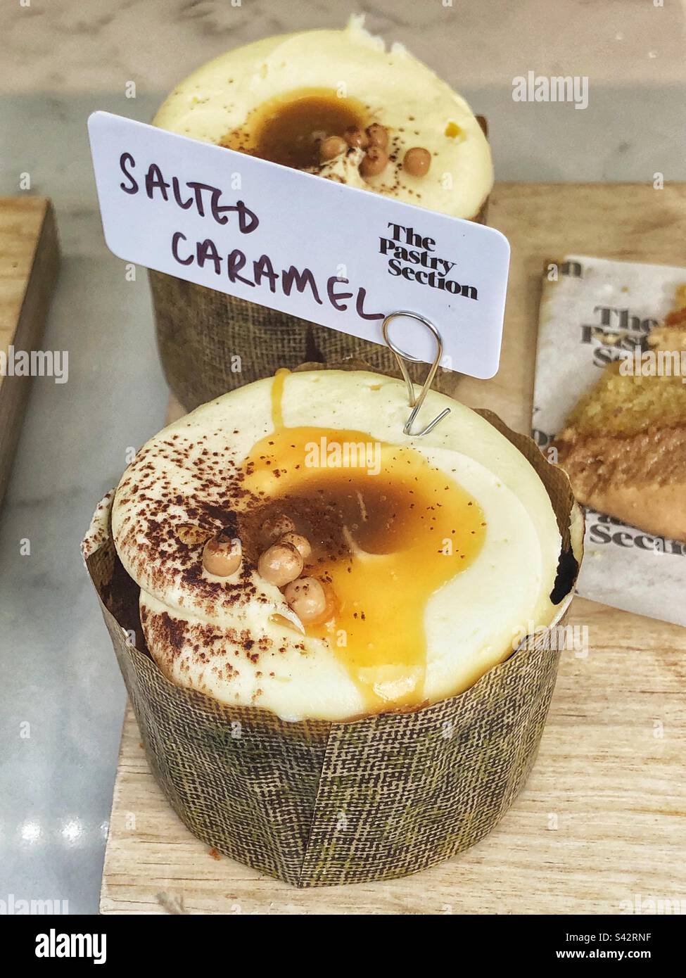 Salted Caramel cake in bakery shop window - Smartphone Captured Stock Image