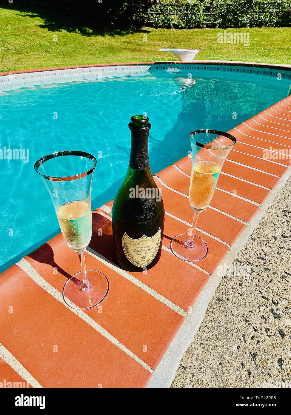 Celebration for two with Don Perignon Champagne, poolside. The good life! - Smartphone Captured Stock Image