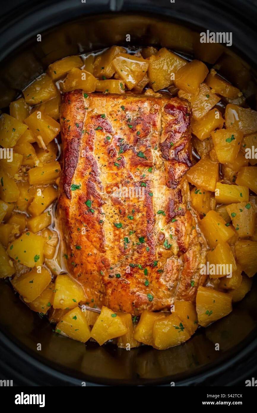 Pork loin and pineapples cooked all day in slow cooker making a