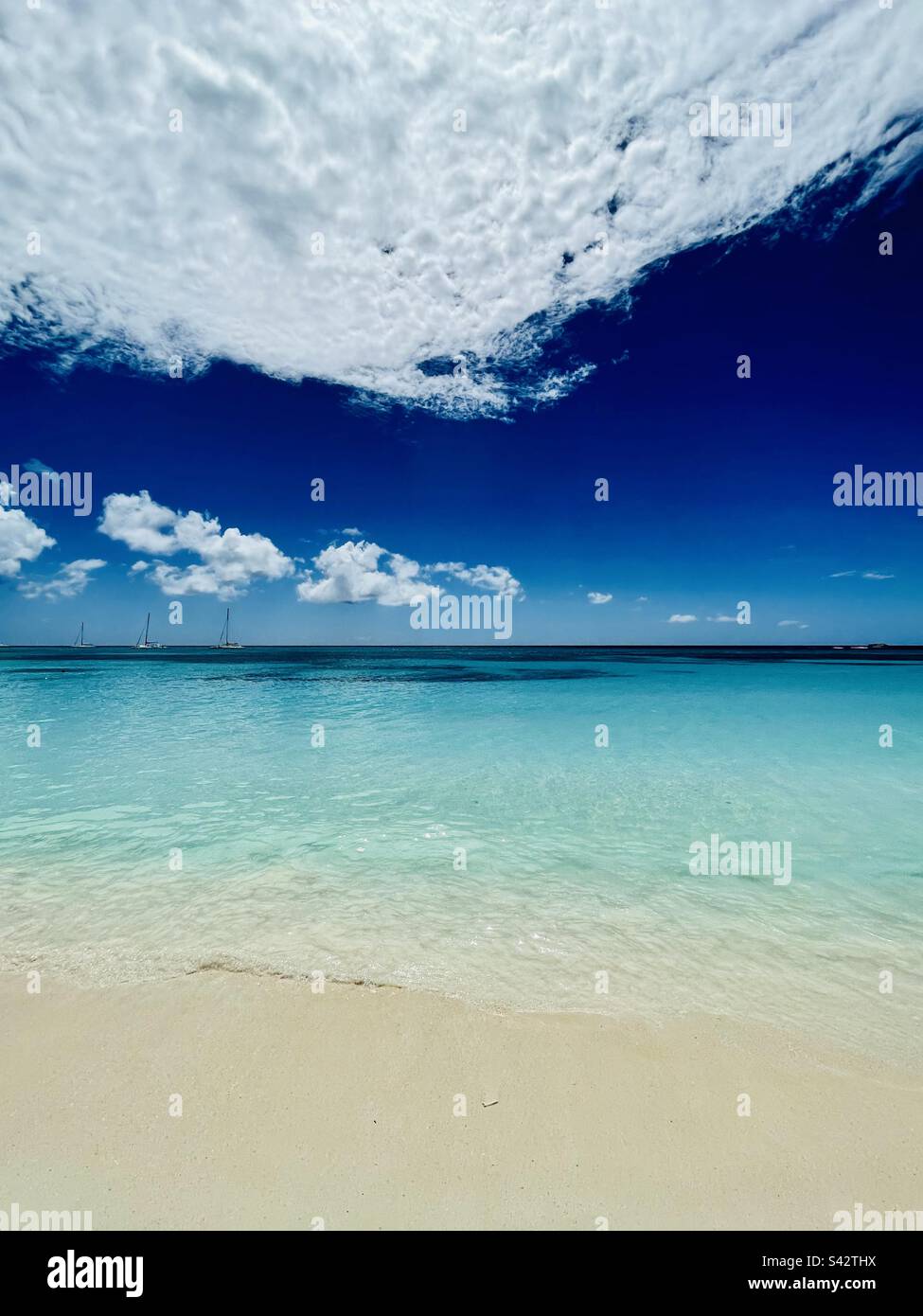 Perfect day in the Caribbean, beach scene with crystal clear water and warm weather - Smartphone Captured Stock Image