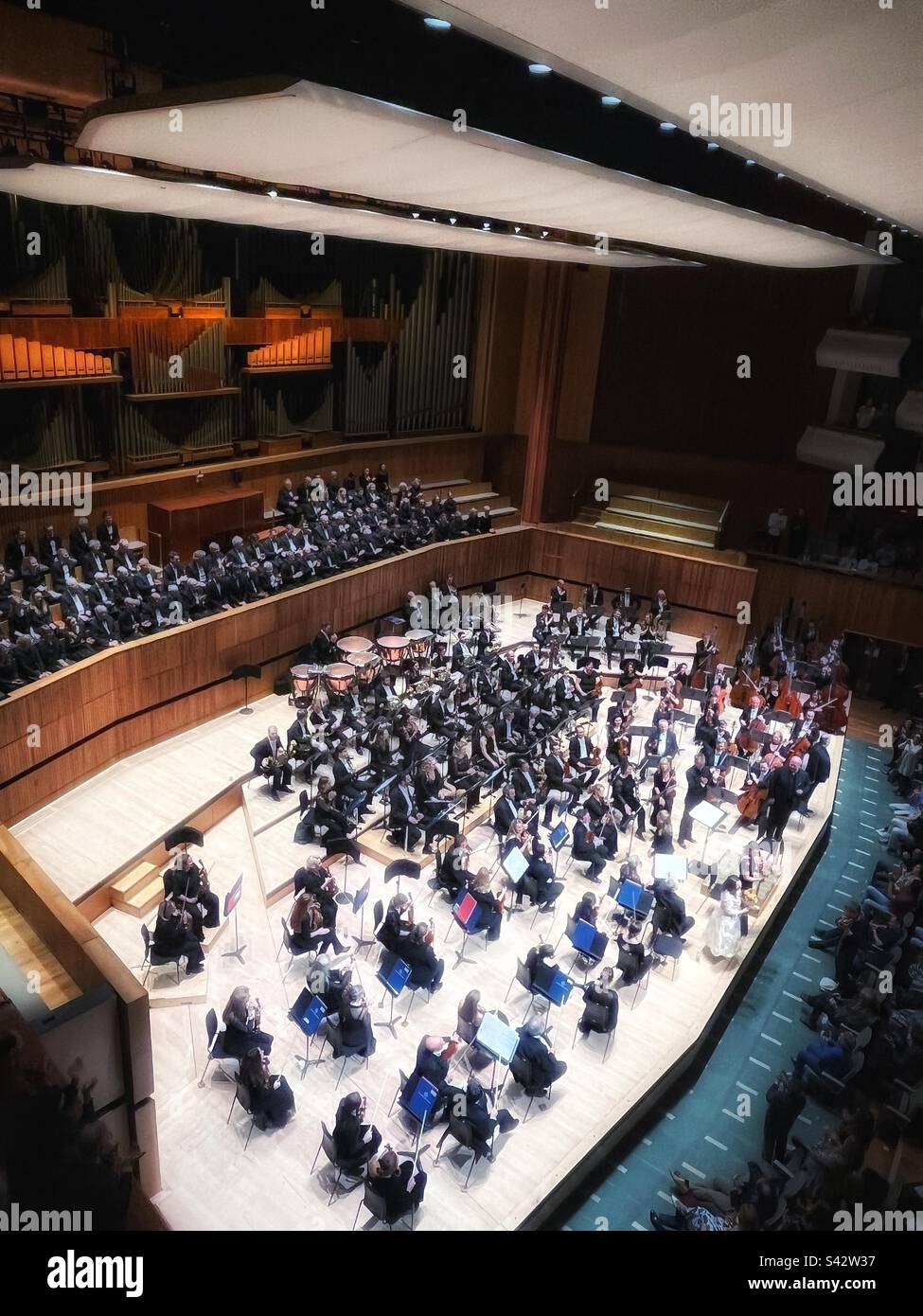 Birds Eye view, perspective of the Royal Philharmonic Orchestra with V. Petrenko conductor, Elizabeth Watts soprano,  Claudia Huckle contralto, Nicky Spence tenor The Bach Choir standing in the RFH - Smartphone Captured Stock Image