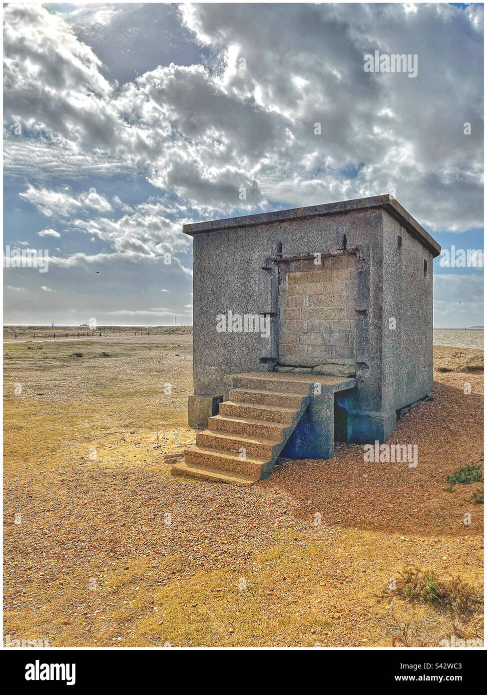 Concrete building with bricked-up entrance on Felixstowe beach - Smartphone Captured Stock Image