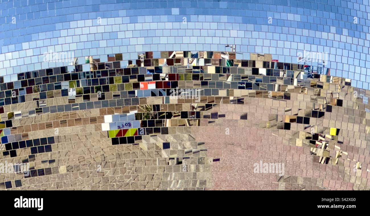 A close up of the giant glitter ball on the promenade at Blackpool with the sea and surroundings reflected in it - Smartphone Captured Stock Image