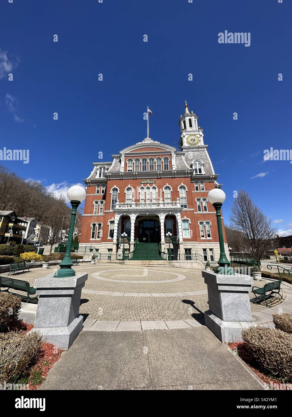 Norwich City Hall nestled on a slope within a hilly section of the downtown area. Located in Norwich, Connecticut, USA. Taken with wide angle lens during early spring. - Smartphone Captured Stock Image