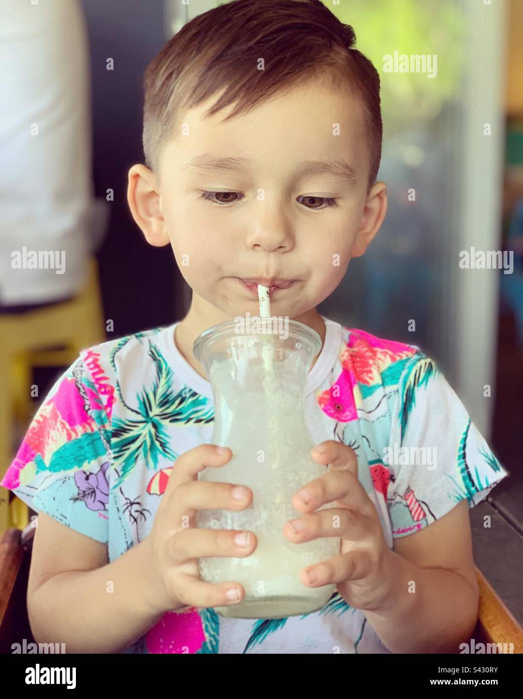 Boy drinks a milkshake Stock Photo