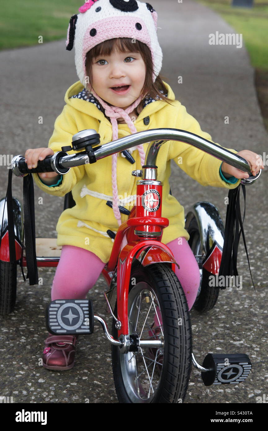 Young girl riding a trike Stock Photo Alamy