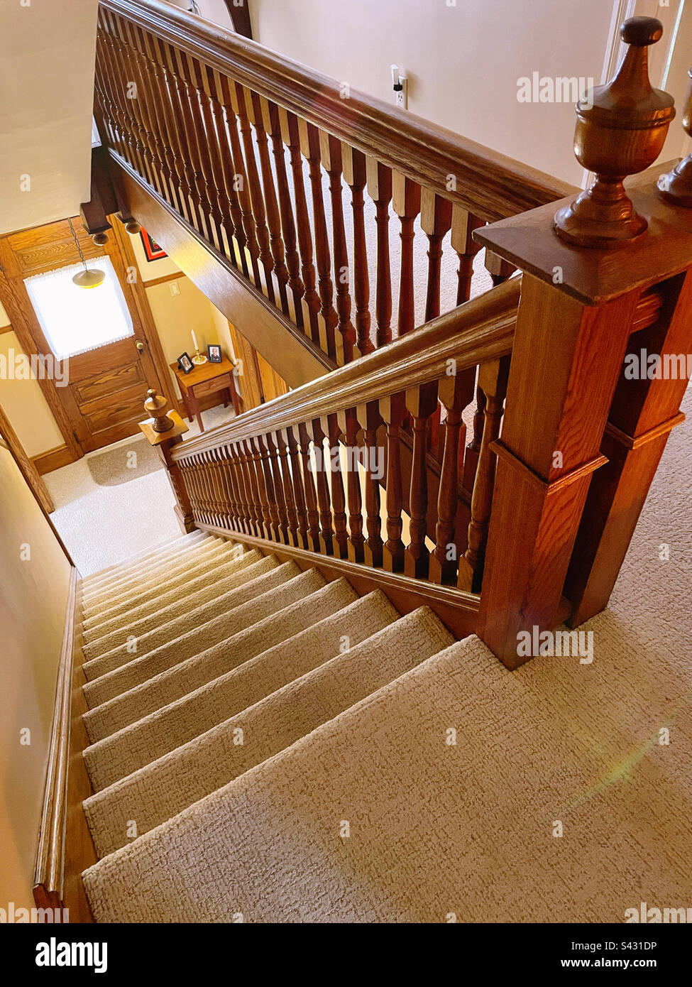 Graceful staircase with wooden banister with finials in an early American residential home in