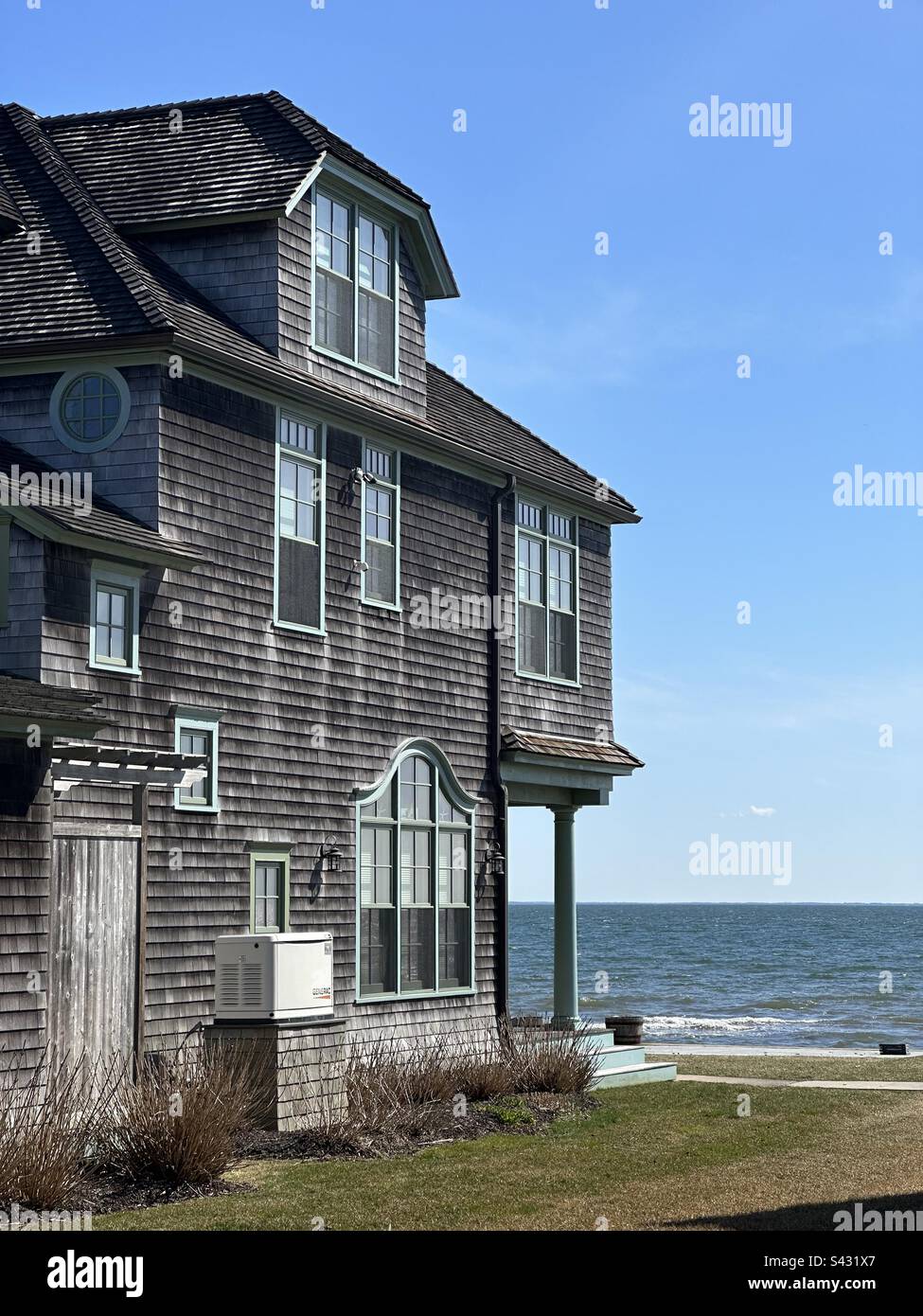 Wooden shingled house along the water, the Long Island Sound. Taken in