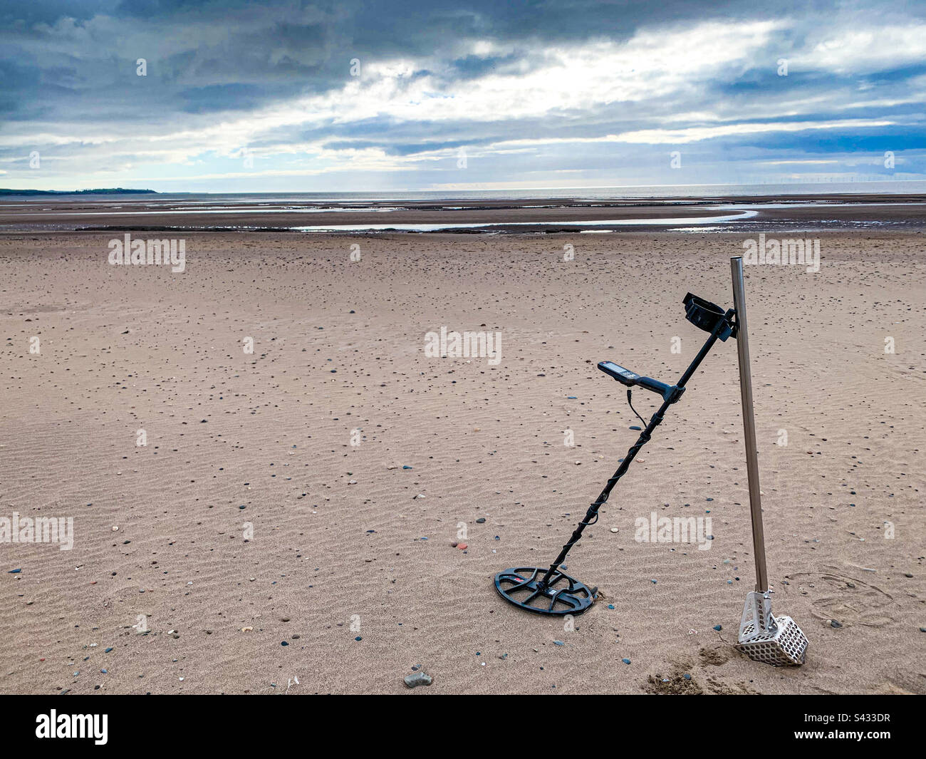 Metal detecting on beach Stock Photo Alamy