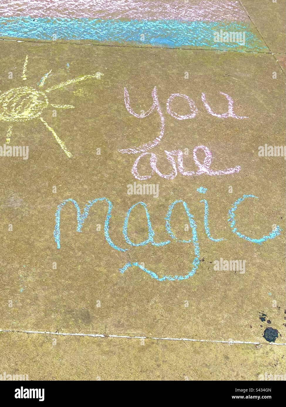 Sidewalk chalk drawing, says YOU ARE MAGIC. - Smartphone Captured Stock Image