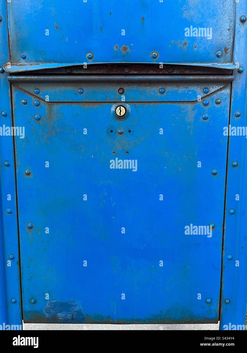 Close up on lower portion of bright blue US Mail box. Includes print space, - Smartphone Captured Stock Image