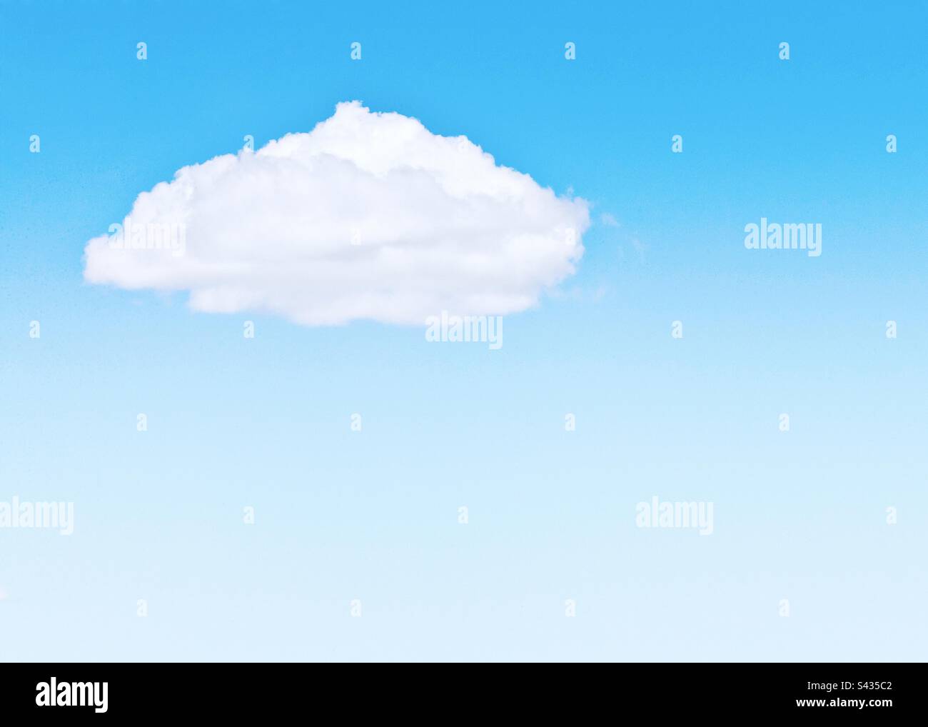 Clear blue sky with a single white fluffy cloud Stock Photo
