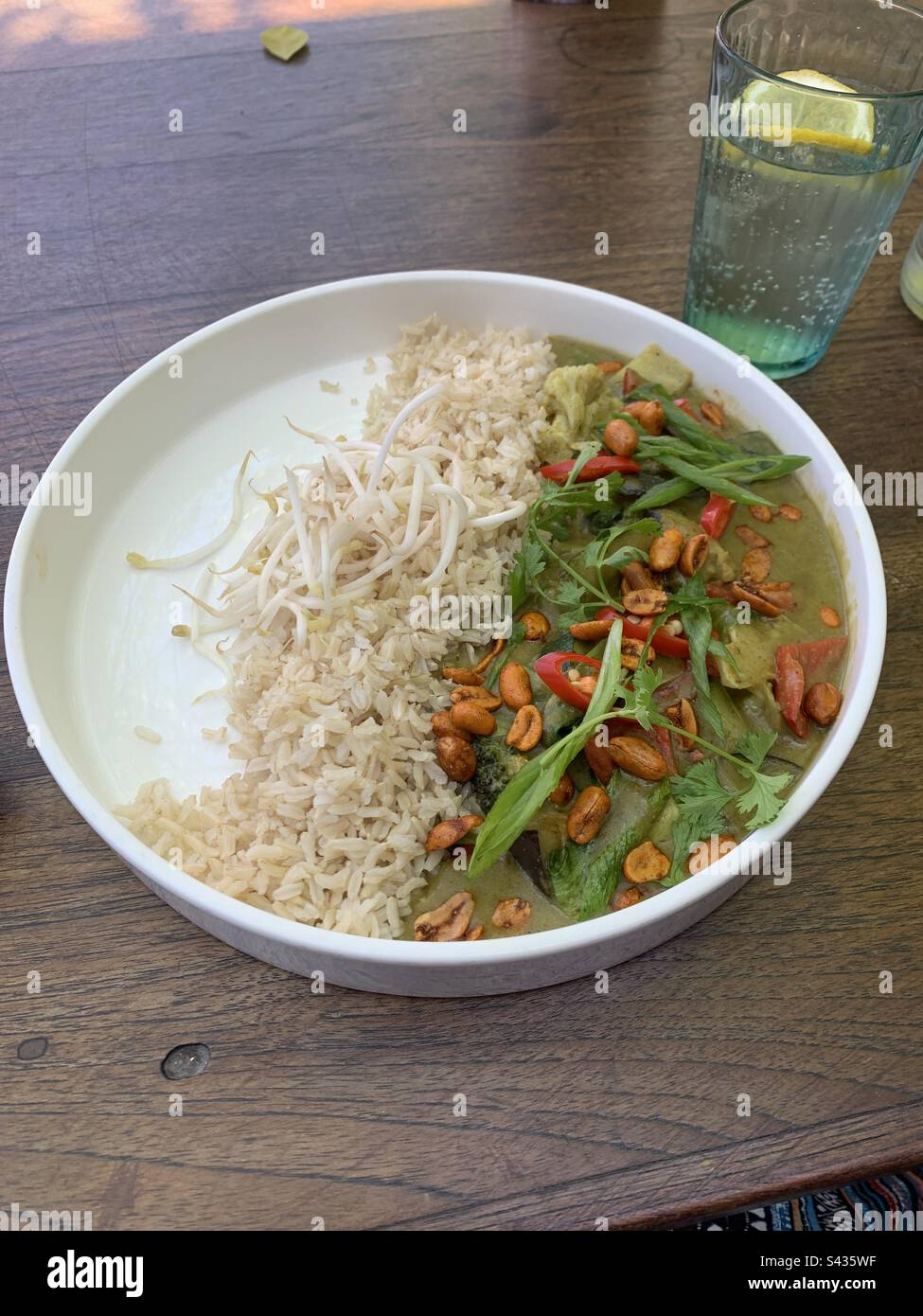 Closeup image of a Thai vegetable curry served with brown rice in a bowl - Smartphone Captured Stock Image